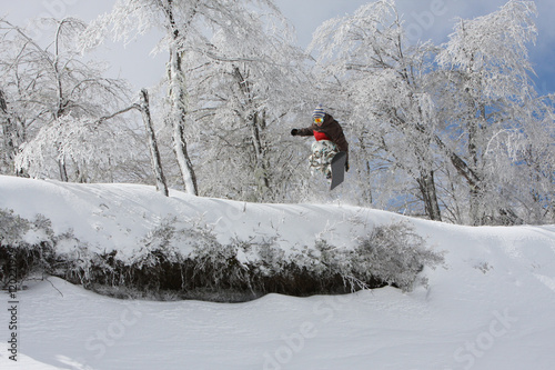 Snowboarder Going off a Jump Over Some Rocks While Trying to Grab His Board at Nevados de Chillan Ski Resort in Las Trancas, Chile