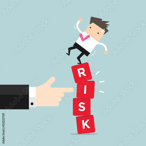 Businessman standing on shaky risk blocks by hand of manager. 