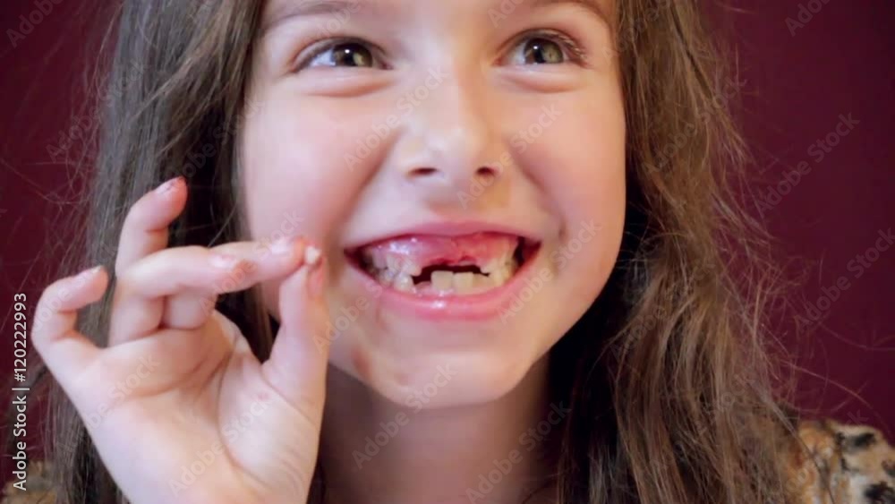 Excited little girl beaming with pride after pulling her own tooth. Excited little girl beaming with pride after pulling her own tooth.