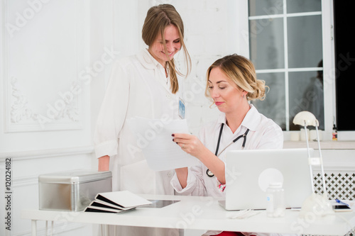 Doctor and nurse looking at docments in medical office