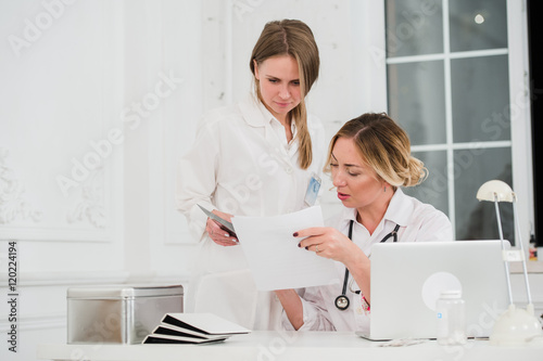 Doctor and nurse looking at docments in medical office