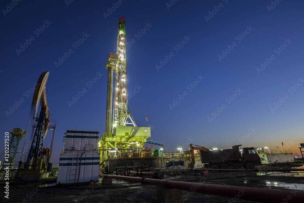 oilfield derrick at night