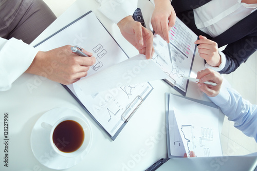 Closeup of human hands working with documents and analyzing business