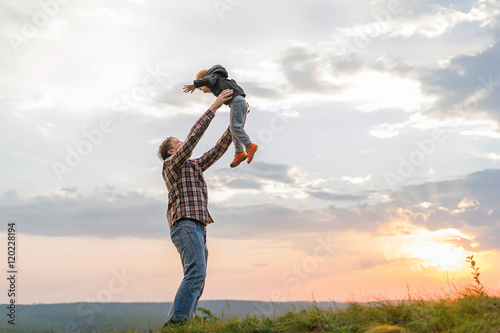 Father tossing up his son.
