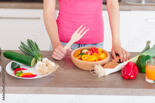 beautiful young girl preparing a healthy dinner
