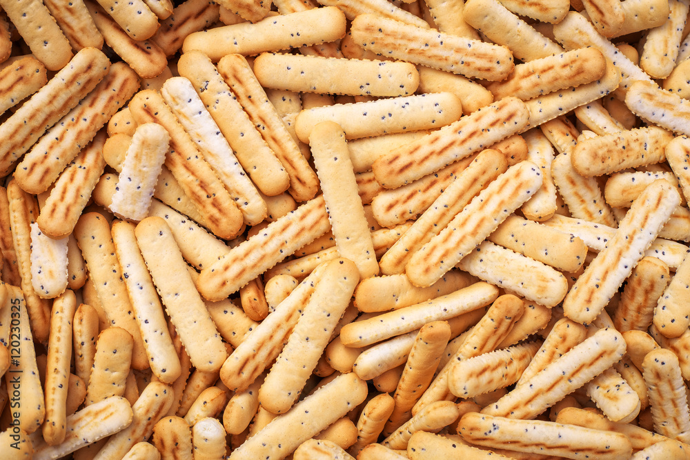 Bread sticks with poppy seeds as background Bread sticks with poppy seeds as background