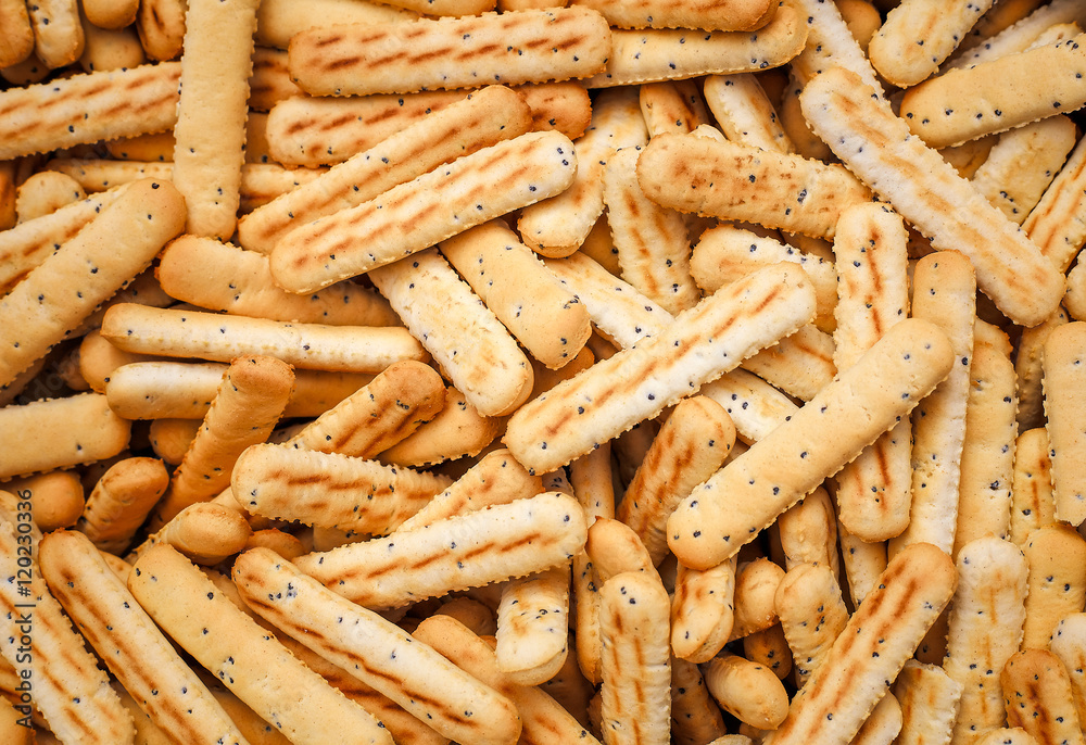 Bread sticks with poppy seeds as background Bread sticks with poppy seeds as background