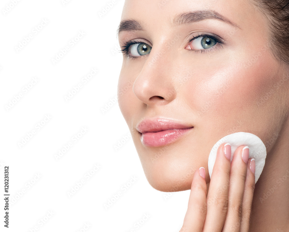 Woman using cotton pad. Happy smiling beautiful young woman clea Woman using cotton pad. Happy smiling beautiful young woman clea