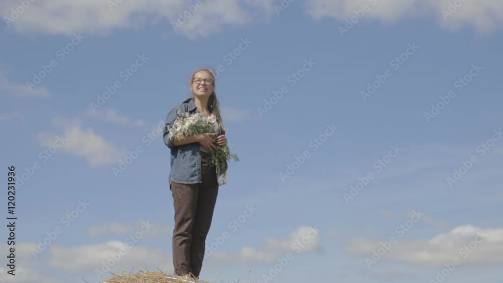 girl with a bouquet of daisies on a background of blue sky. girl with a bouquet of daisies on a background of blue sky.