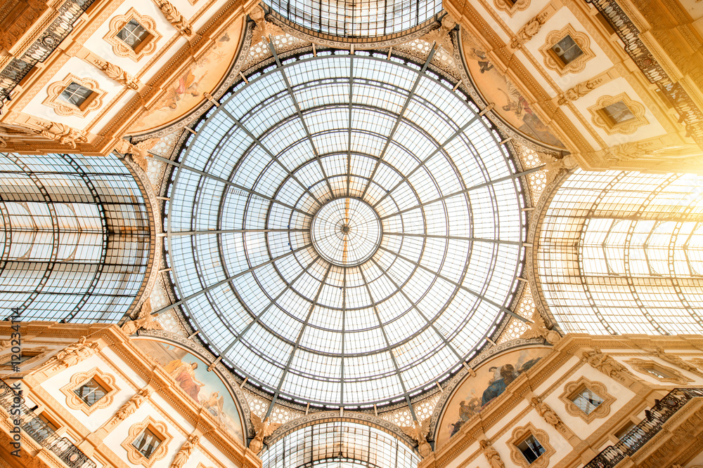 Interior with beautiful glass vaults in the famous Vittorio Emanuele shopping gallery in the center of Milan city.