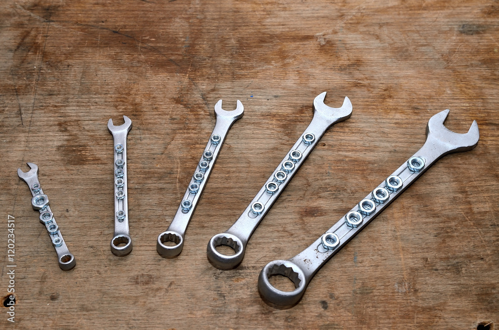 Wrenches and nuts / Wrench set on the old dirty desk. Wrenches and nuts / Wrench set on the old dirty desk.