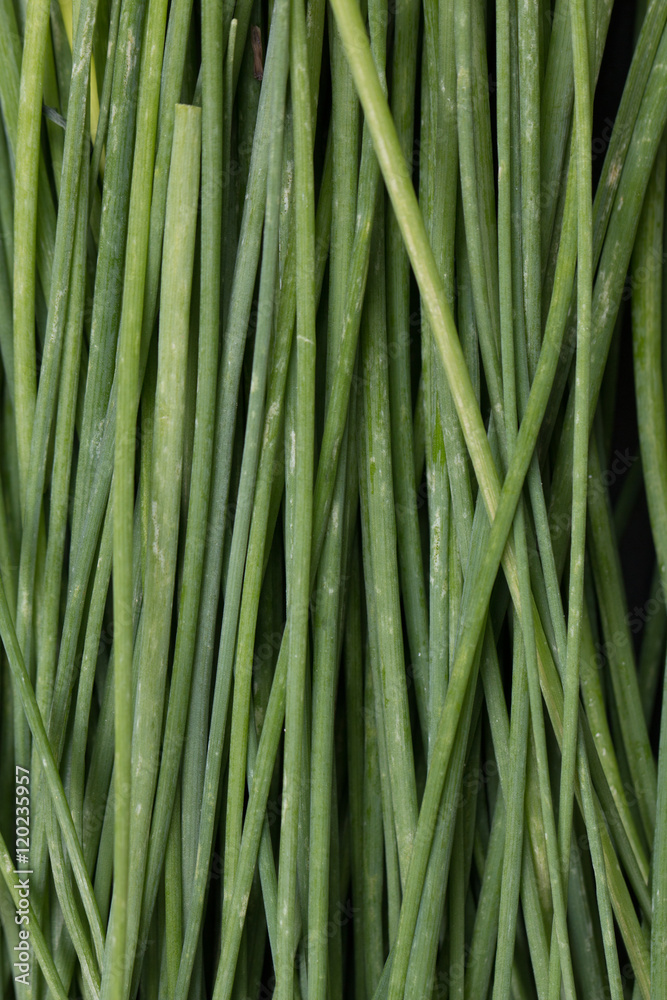 bunch of fresh chives on a wooden cutting board, selective focus bunch of fresh chives on a wooden cutting board, selective focus