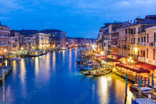 Traditional architecture and boats among the Grand canal in Rialto area on Venice city