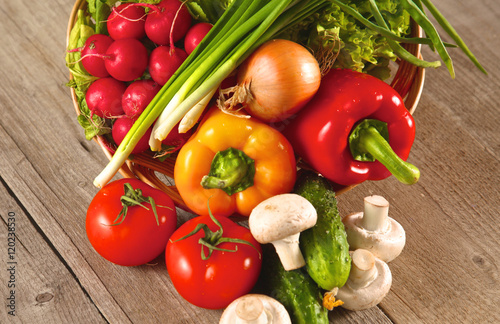 Composition with assorted raw organic vegetables wooden table