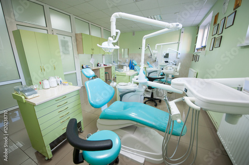 Modern dental clinic with three dental chairs and equipments