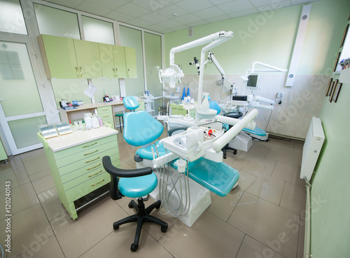 Dentist chairs with modern tools at bright treatment room at the hospital. Dentistry