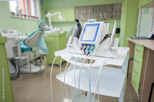 Medical equipment and device in dental office on the background of dental chairs and other tools used by dentists