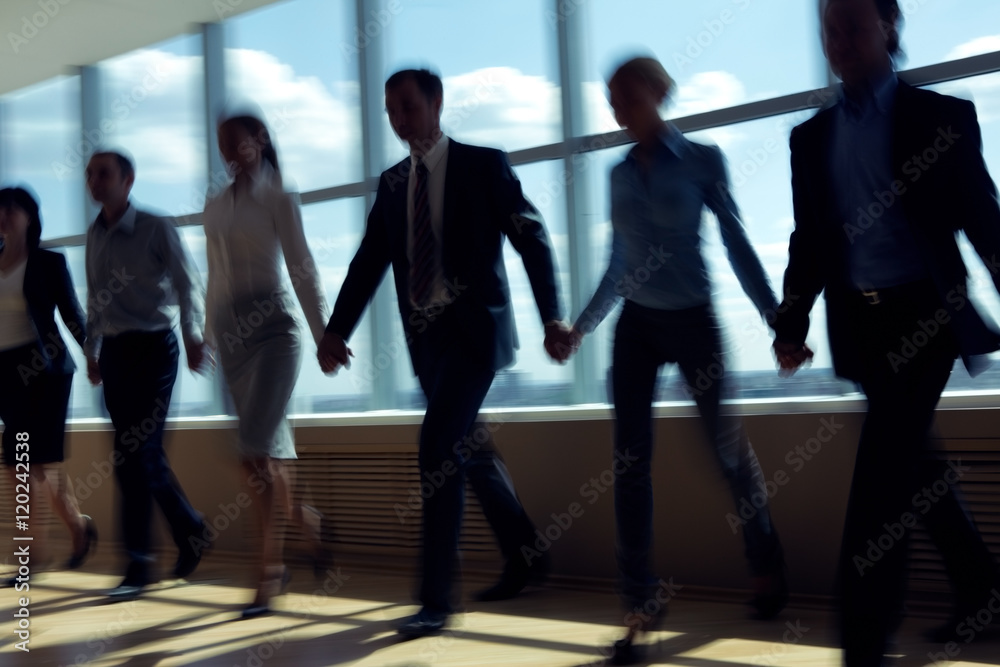 Group of business people holding hands and walking