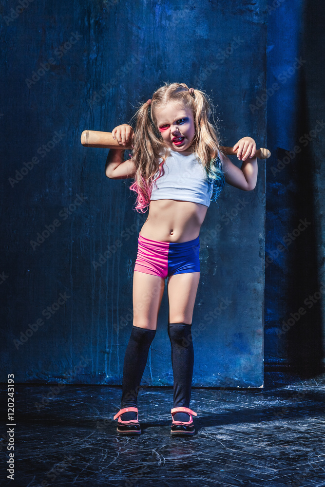 Little girl pointing in toy gun