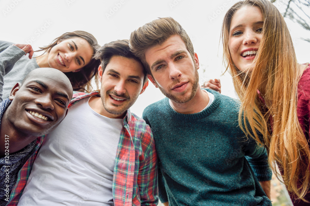 Multiracial group of friends taking selfie Multiracial group of friends taking selfie
