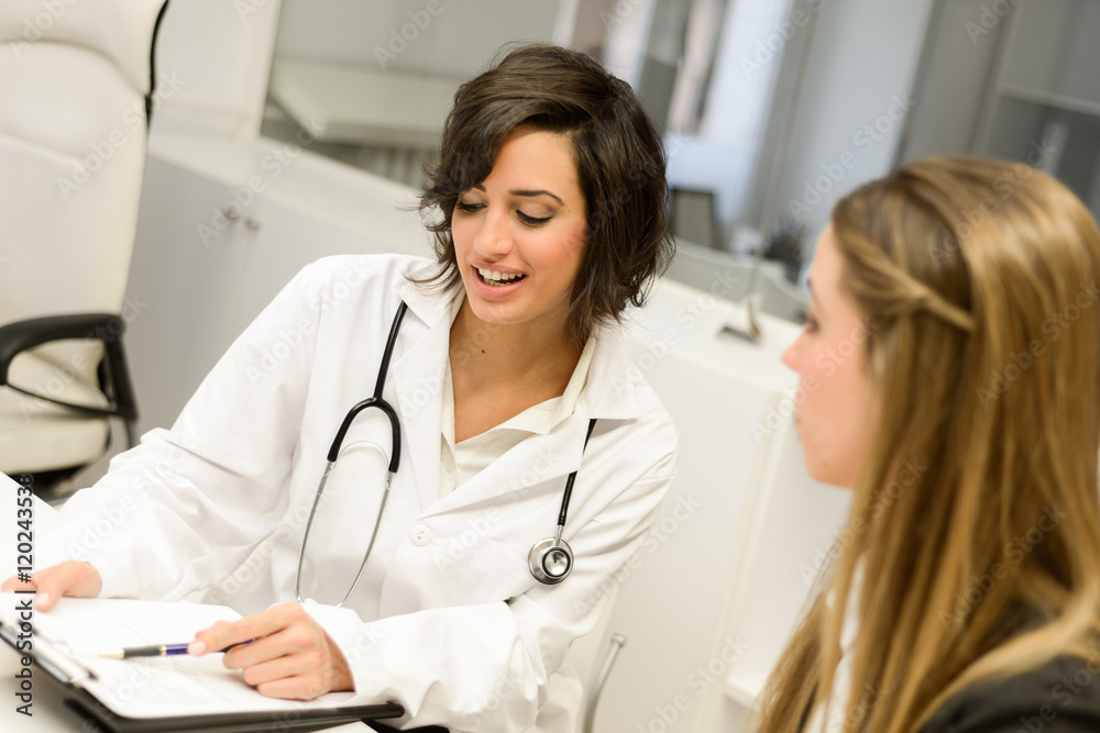 Doctor explaining diagnosis to her female patient Doctor explaining diagnosis to her female patient