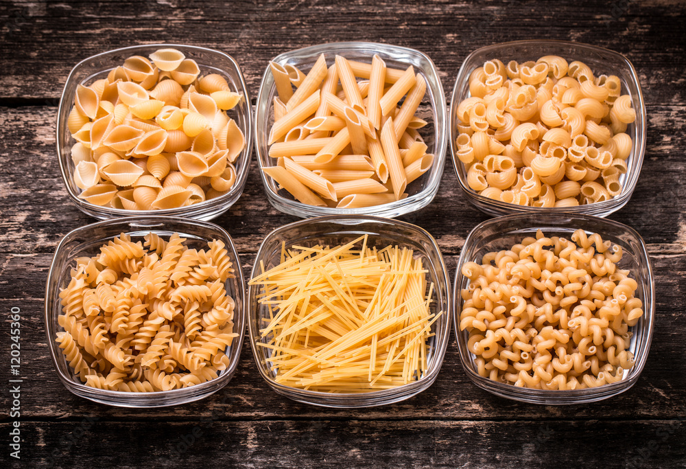 Various mix of pasta on wooden rustic background. Diet and food Various mix of pasta on wooden rustic background. Diet and food