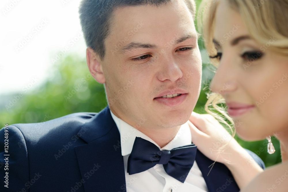 Wedding couple on the nature is hugging each other. Beautiful model girl in white dress. Man in suit. Beauty bride with groom. Female and male portrait. Woman with lace veil. Lady and guy outdoors Wedding couple on the nature is hugging each other. Beautiful model girl in white dress. Man in suit. Beauty bride with groom. Female and male portrait. Woman with lace veil. Lady and guy outdoors