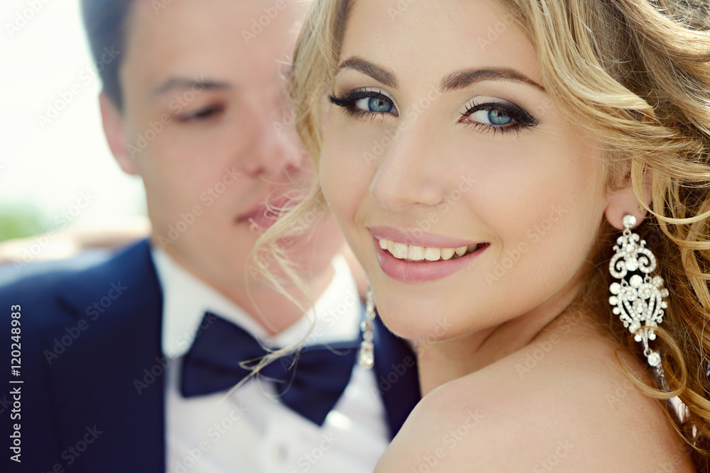 Wedding couple on the nature is hugging each other. Beautiful model girl in white dress. Man in suit. Beauty bride with groom. Female and male portrait. Woman with lace veil. Lady and guy outdoors Wedding couple on the nature is hugging each other. Beautiful model girl in white dress. Man in suit. Beauty bride with groom. Female and male portrait. Woman with lace veil. Lady and guy outdoors