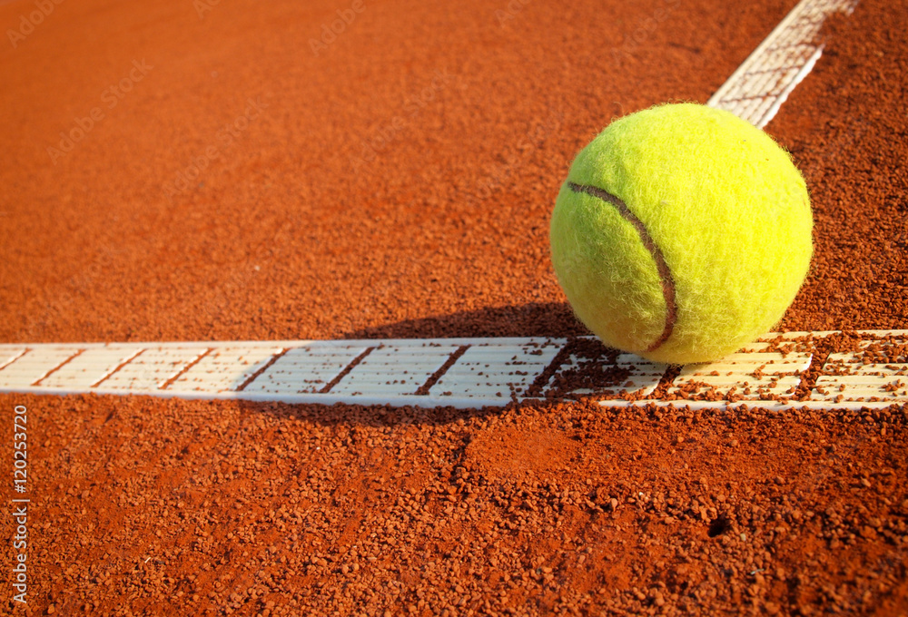 Tennis ball on a tennis clay court