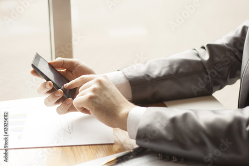 Man using mobile smartphone. Shot with third-person view 