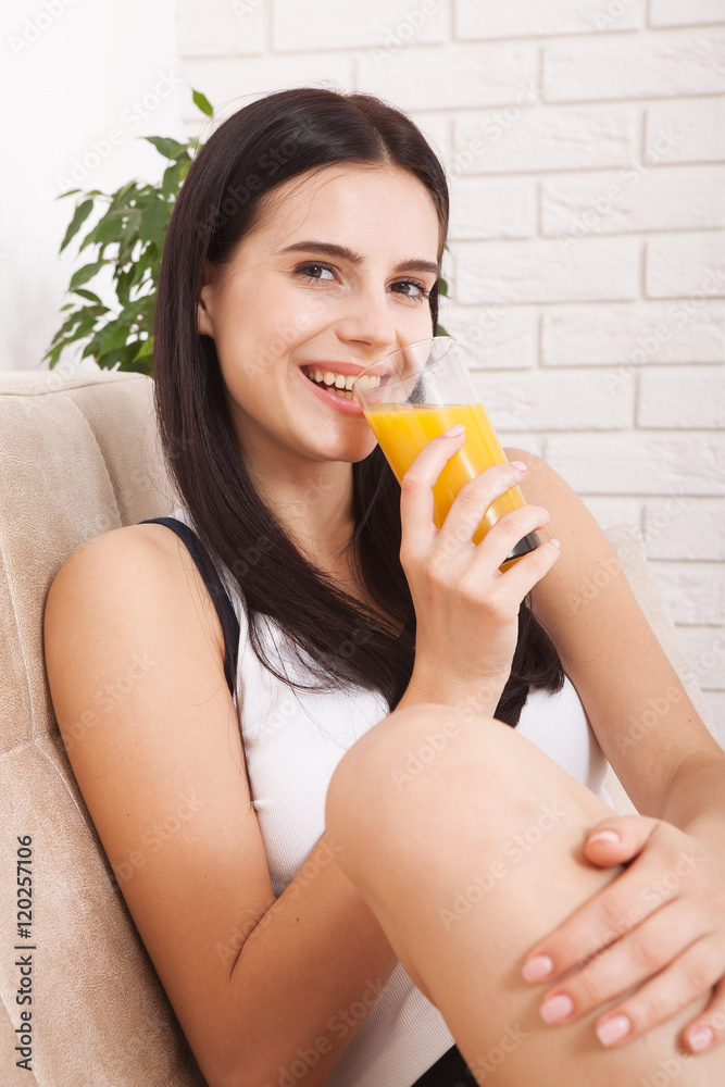Woman drinking orange juice Beautiful mixed-race Asian, Caucasian model. Woman drinking orange juice Beautiful mixed-race Asian, Caucasian model.