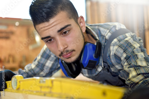 Young man in woodwork training course