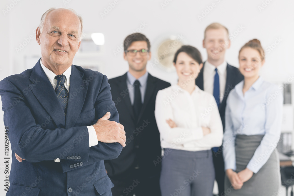 Successful senior businessman and his supportive team Successful senior businessman and his supportive team