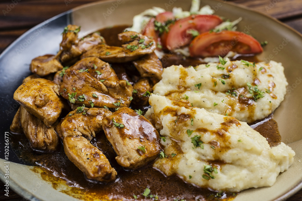 chicken breast with brown gravy sauce and mashed potato