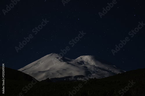 Snowy mountain Elbrus in moonlight and stars at night © kochievmv