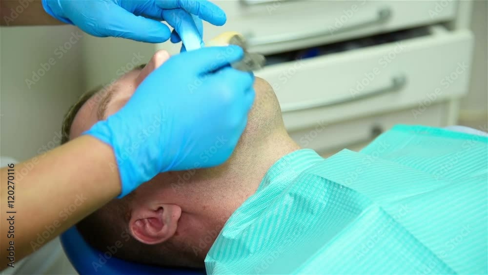 Dentist Takes Iimpression Of Teeth Of Patient. Close Up Dentist Takes Iimpression Of Teeth Of Patient. Close Up