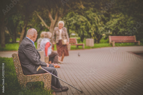 Old people in the park, lonely older man photo