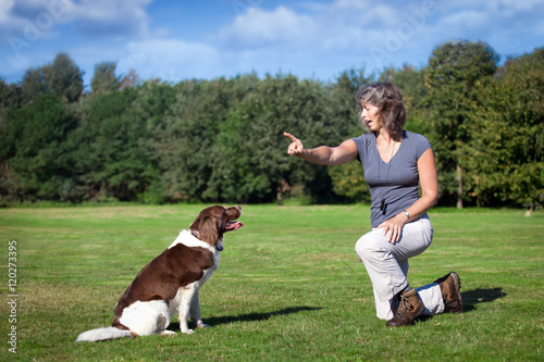 Canvas Print woman teaches her dog a command