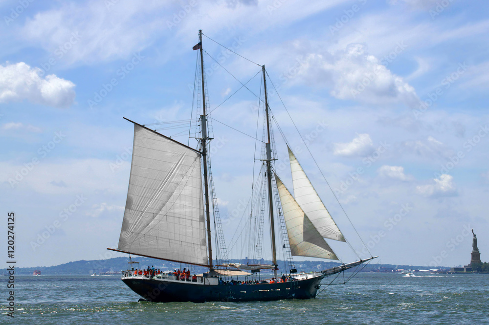 Sailing ship on background of Liberty Island