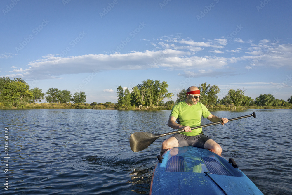 senior male paddler on paddleboard
