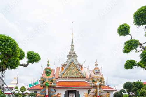 Entrance to Wat Arun buddhist temple,Wat Arun Ratchawararam or the Temple of Dawn. Thailand iconic decorated by ceramics ,Giant statue in wat arun bangkok thailand ,Amazing Thailand