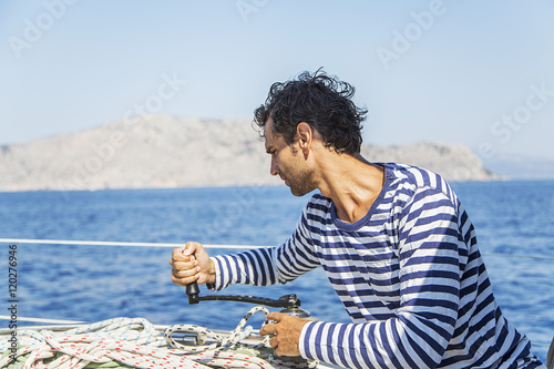 Man in action of pulling rope