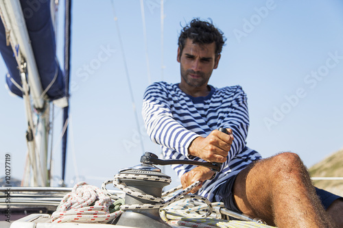 Man in action of pulling rope