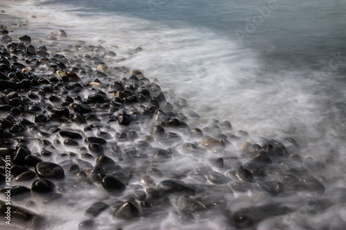 Mystischer Steinstrand mit Wellen auf Skye, Schottland, Langzeitbelichtung