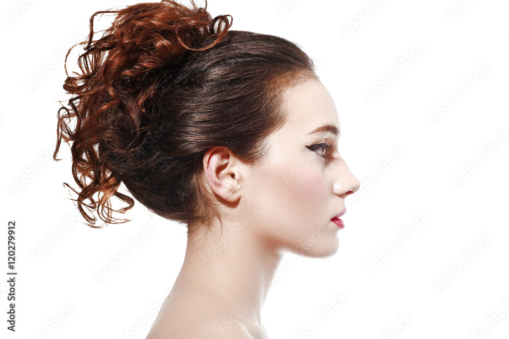 Profile head shot of a beautiful serene young Black woman posing with eyes  closed and curly hair tied to the top of her head over blue Stock Photo -  Alamy