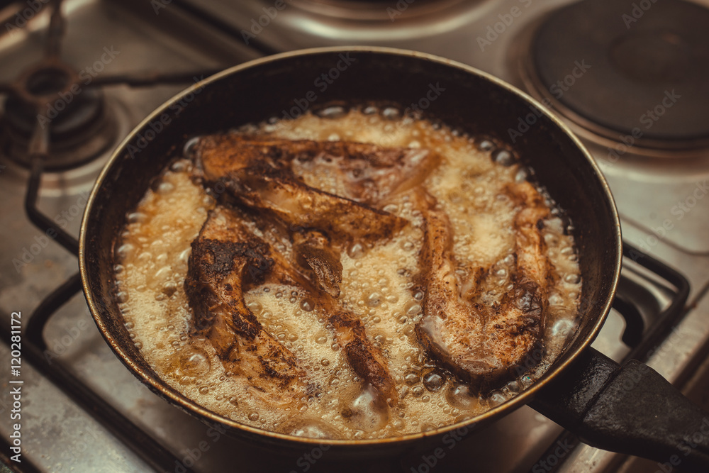 fish frying in a pan fish frying in a pan