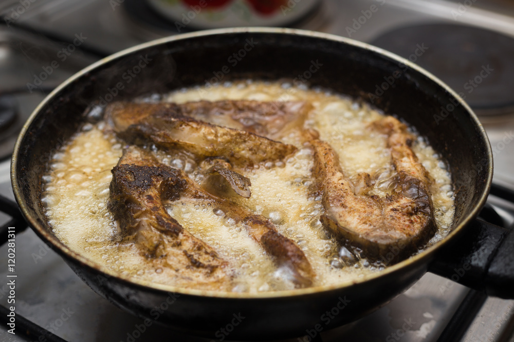 fish frying in a pan fish frying in a pan