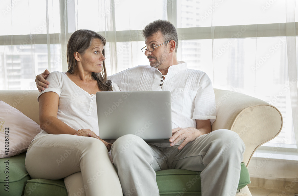 middle aged caouple with a computer middle aged caouple with a computer