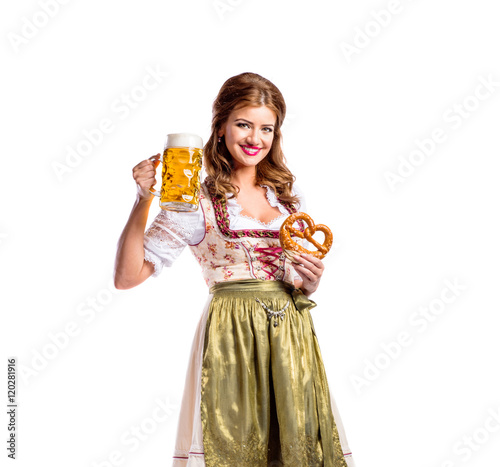 Woman in traditional bavarian dress holding beer and pretzel