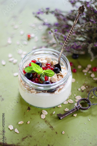 yogurt with berries and products for healthy breakfast, close-up
